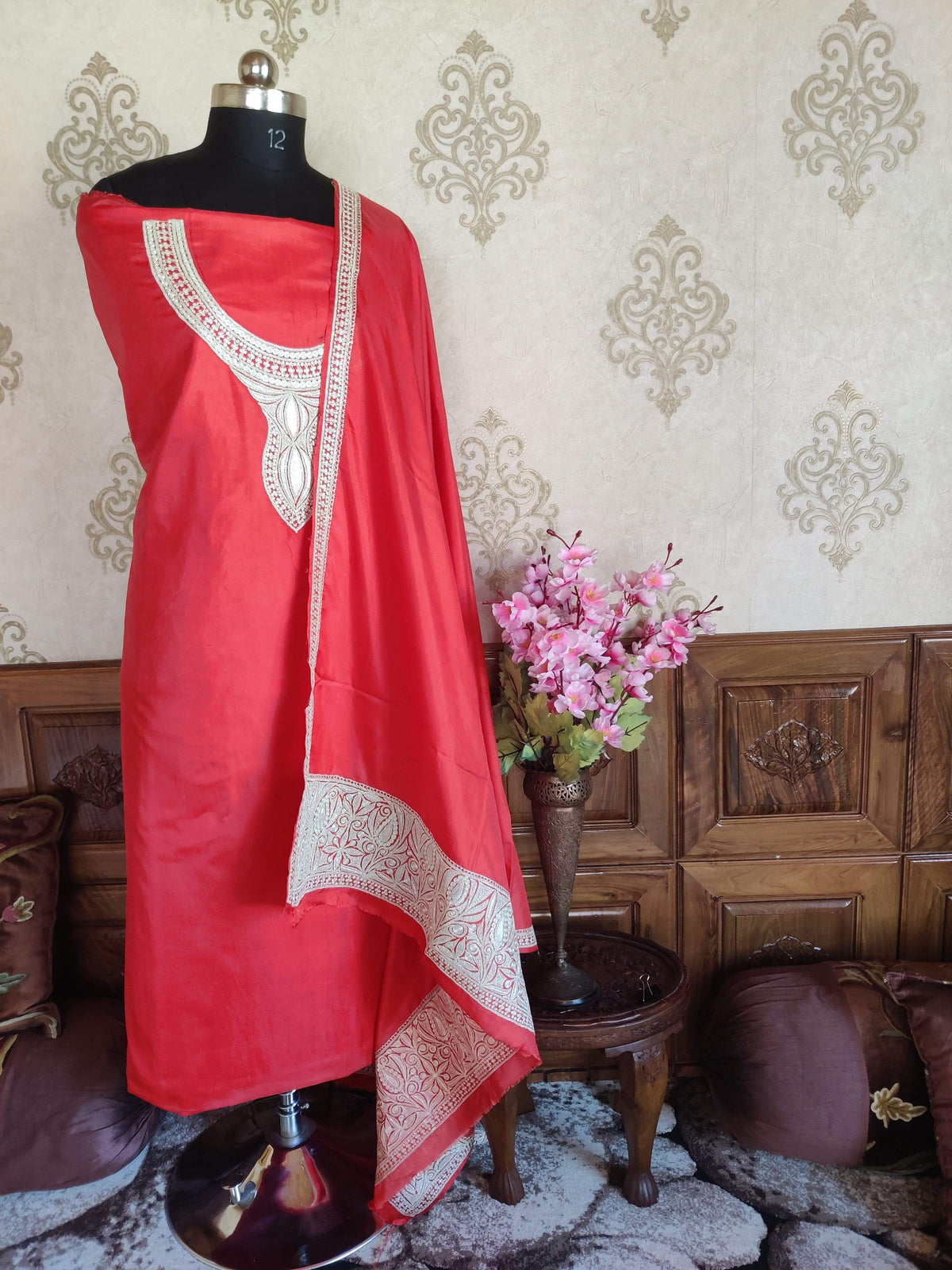 Red silk suit fabric displayed with matching dupatta, showing silver-toned Tilla neckline embroidery and broad end borders
