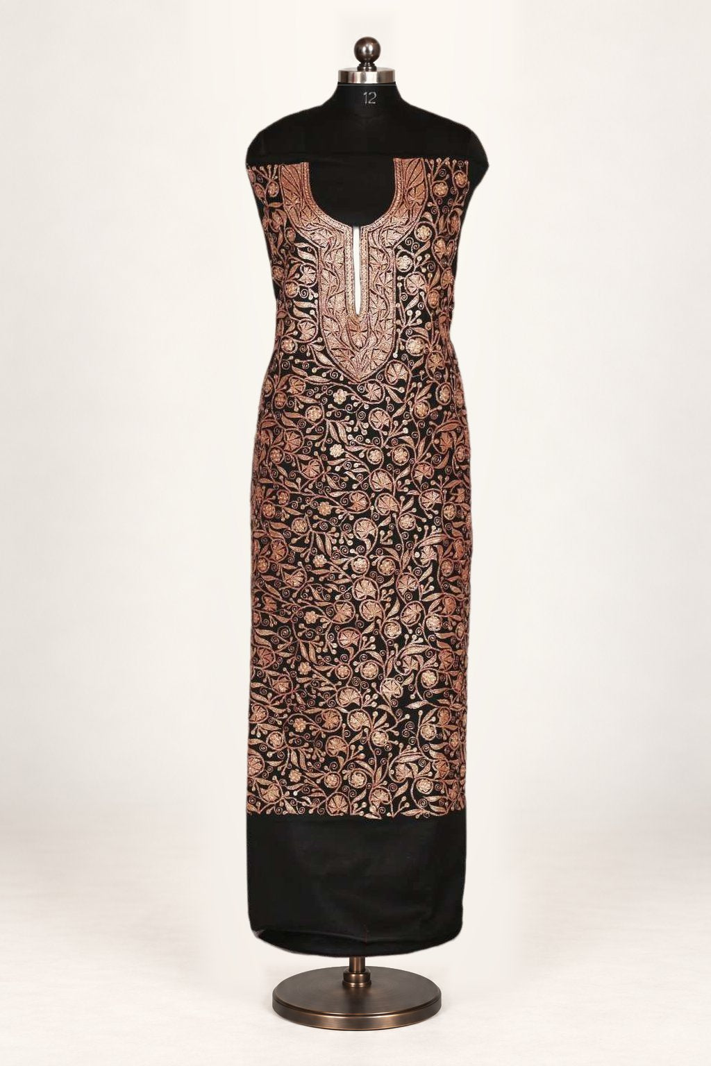 Front view of black suit fabric on a mannequin, with copper-toned Tilla floral vines and an ornate embroidered neckline